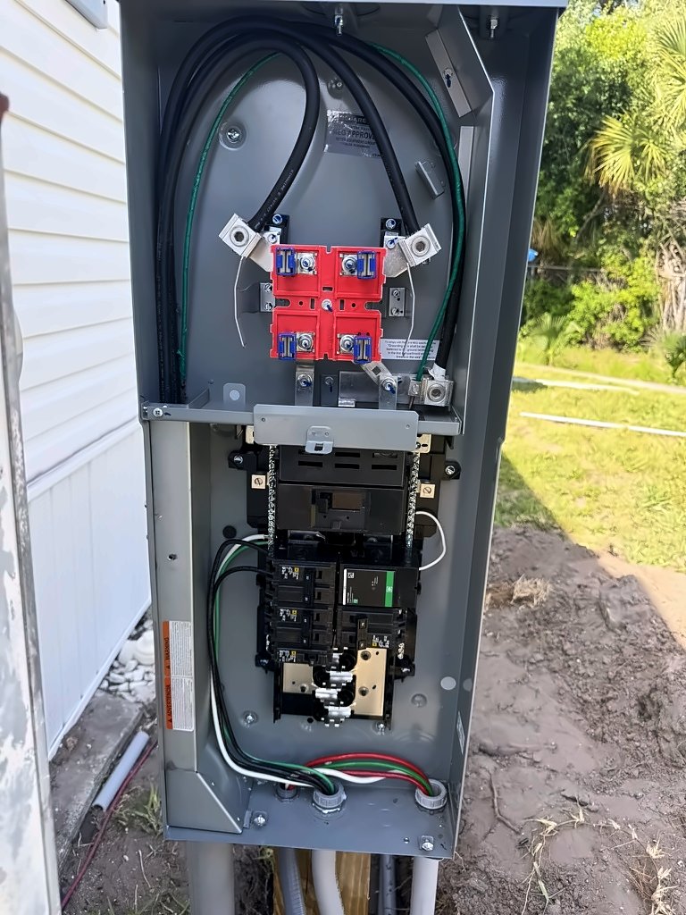 New meter and breaker pedestal at a mobile home, opened up to show the meter socket, breakers and wiring